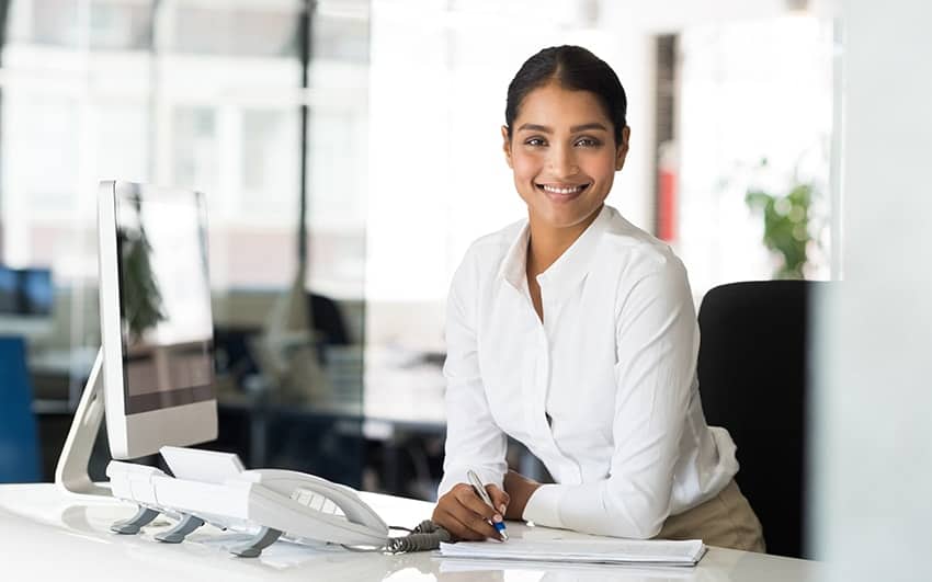 Woman sitting at a desk smiling