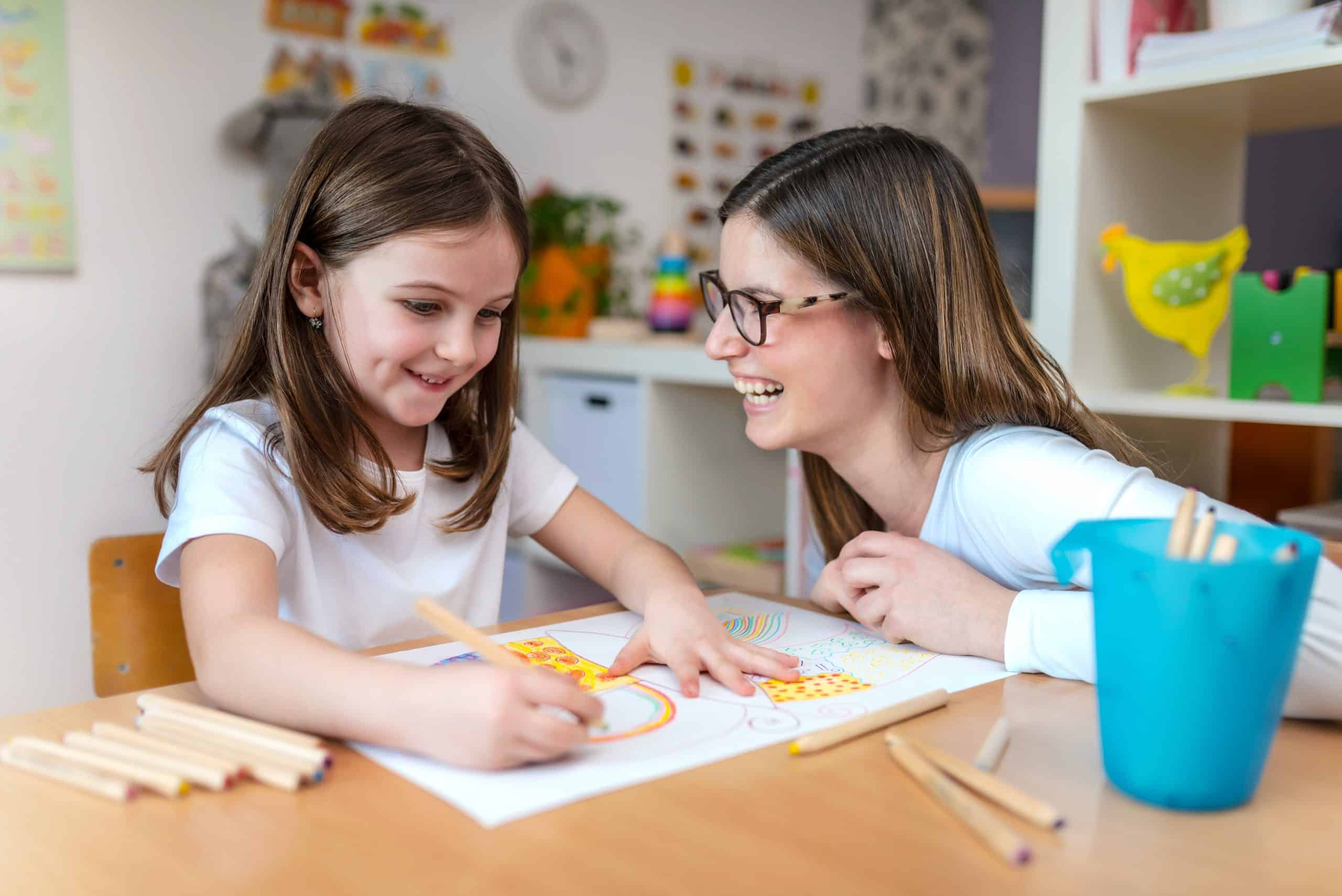 Nanny helping a little girl with homework