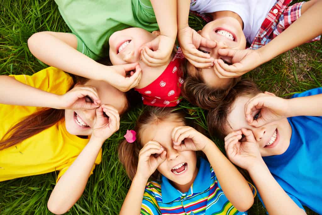 Children resting Group of cute children lying on grass