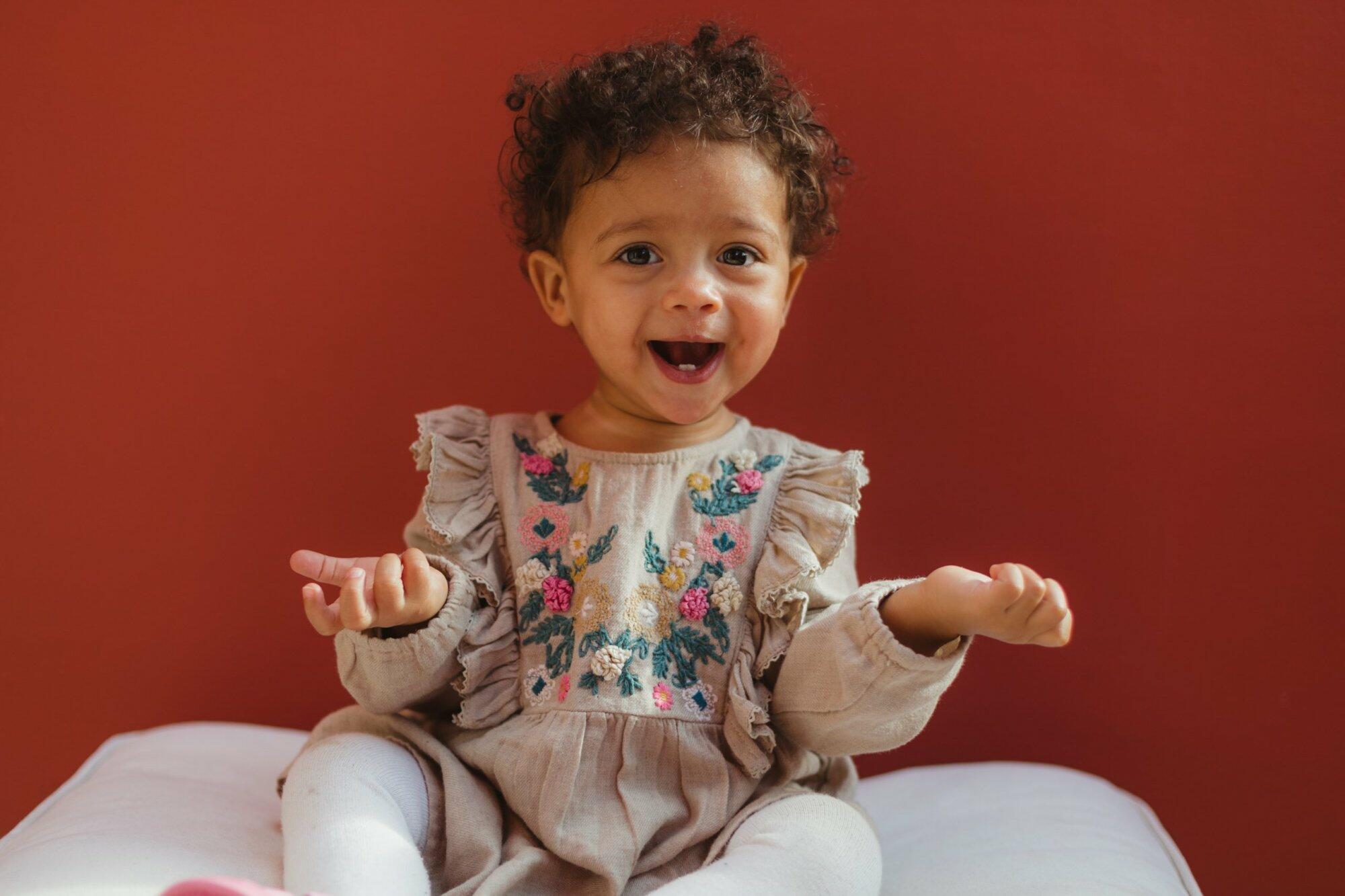 Little girl in a cute dress smiling at the camera – job Little girl in a cute dress smiling at the camera