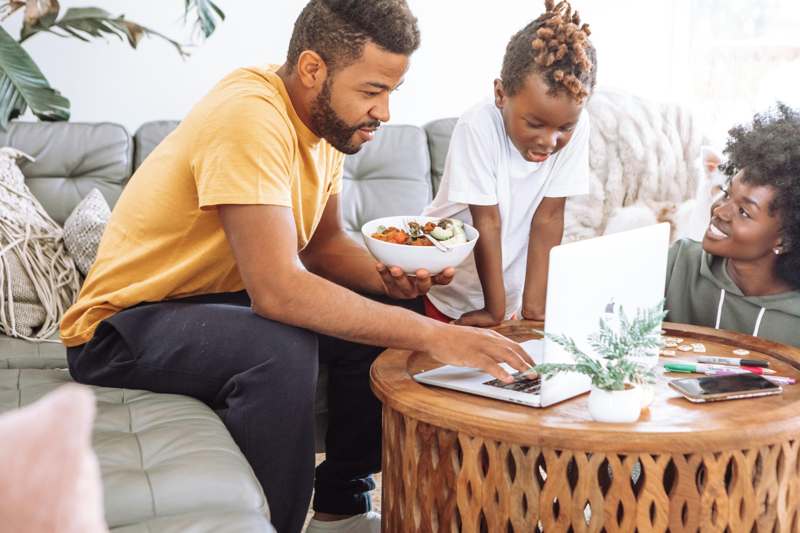 Family looking at a computer and planning events and activities to attend for Black History Month