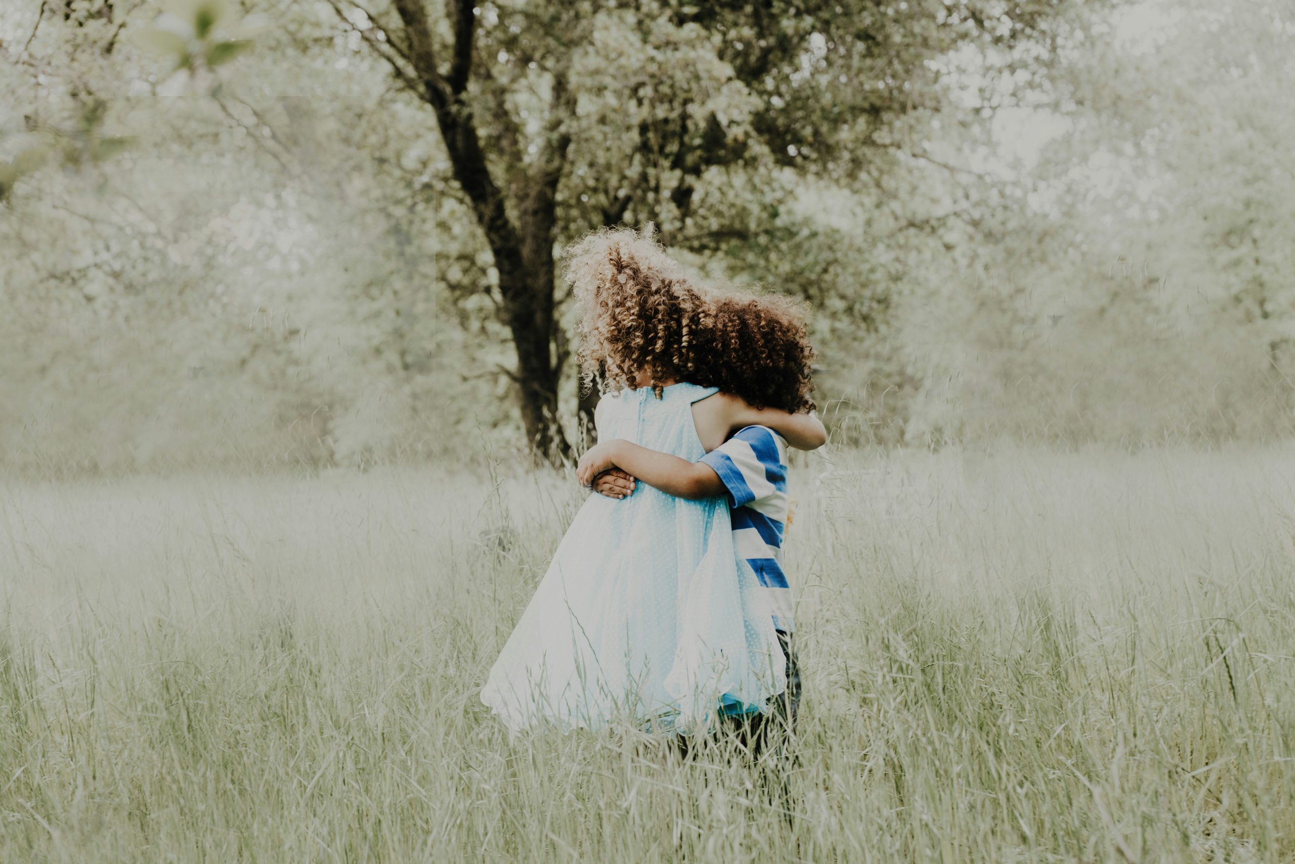 Two children hugging in nature
