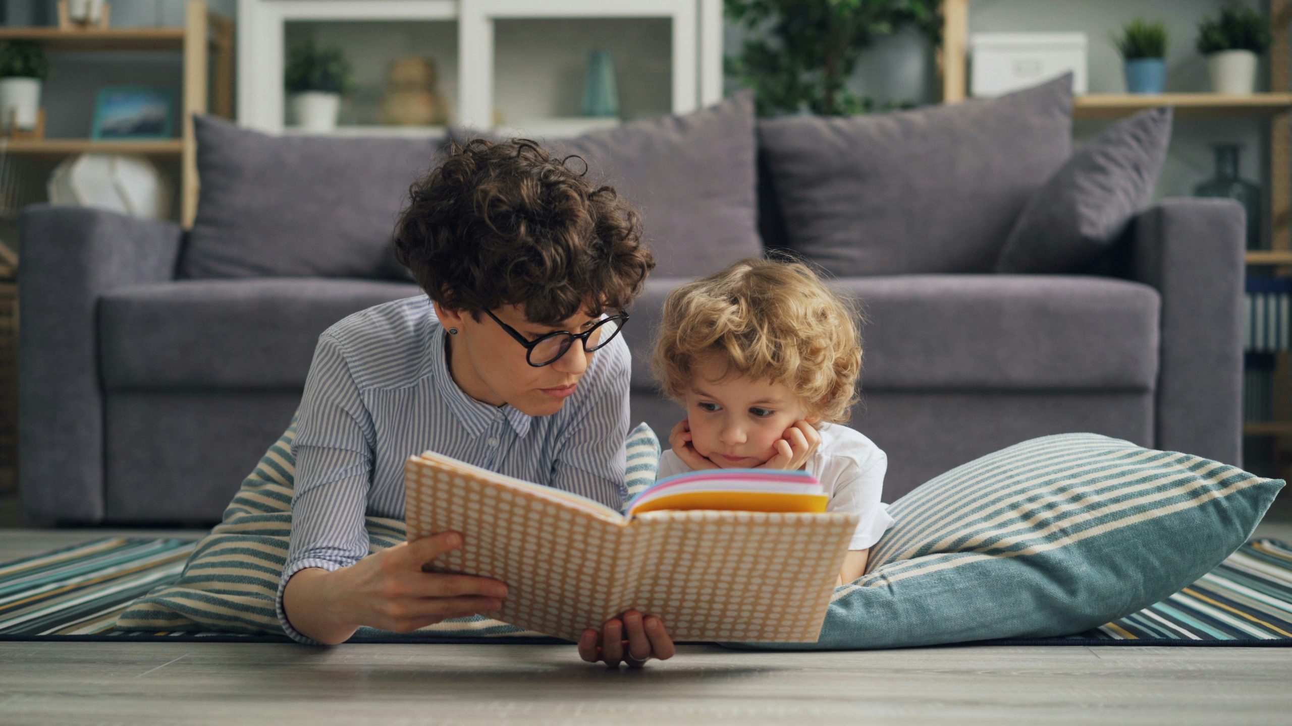 Older and younger child reading a book for Black History Month