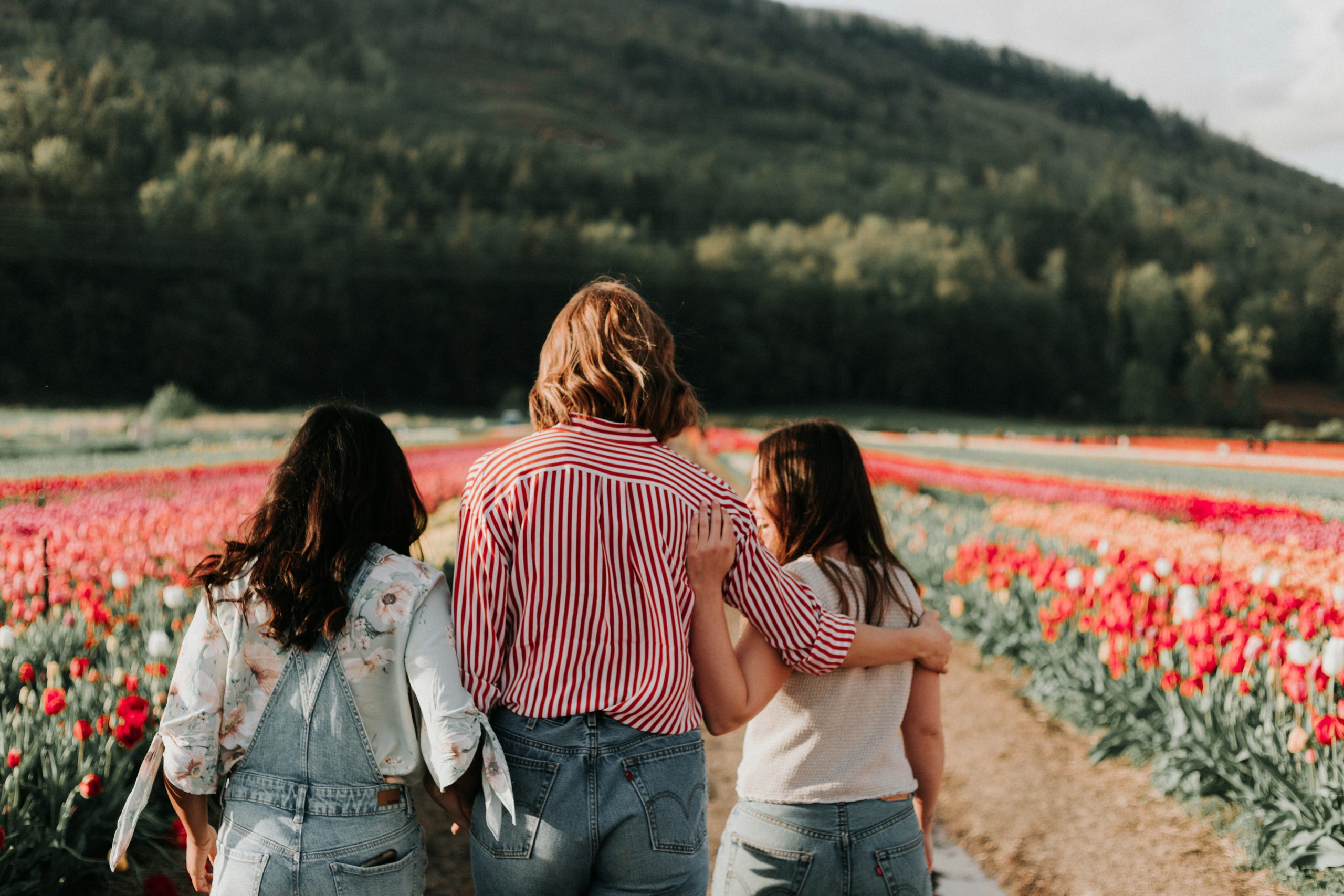 Two girls and a mom in the field of flowers