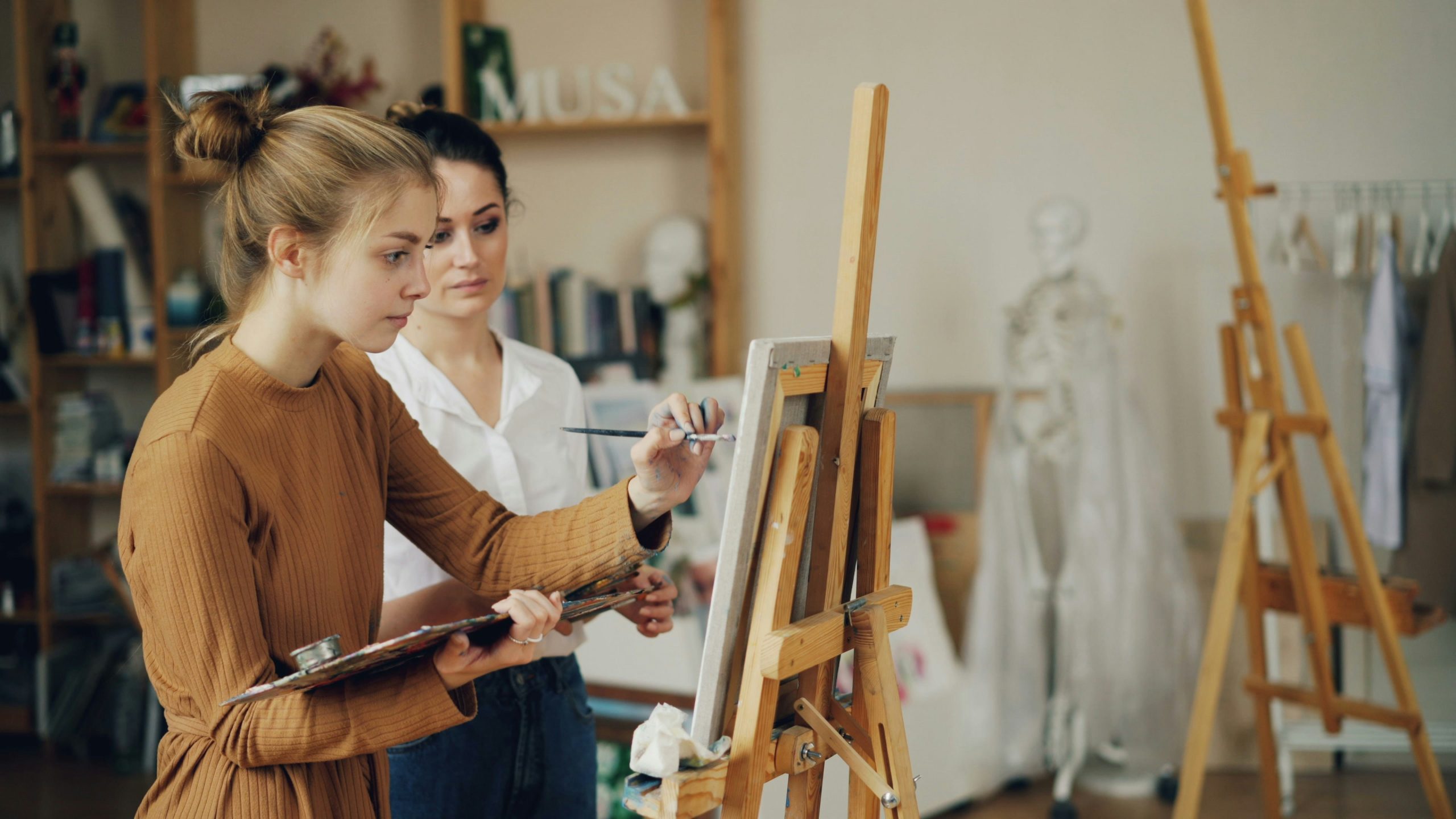 Girl painting a self portrait for Women's History Month